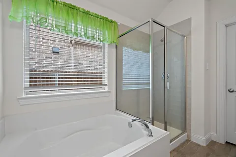 a bathroom with a tub and a shower