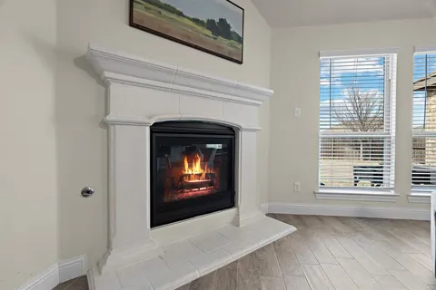 a view of an empty room with a fireplace