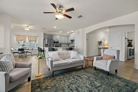 a living room with furniture and kitchen view