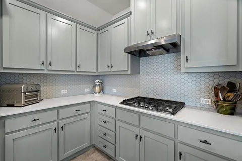 a kitchen with cabinets appliances and a sink