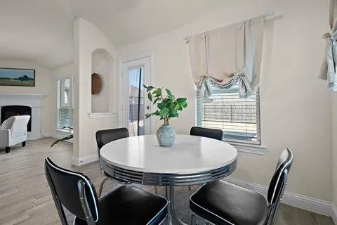 a dining room with furniture and window