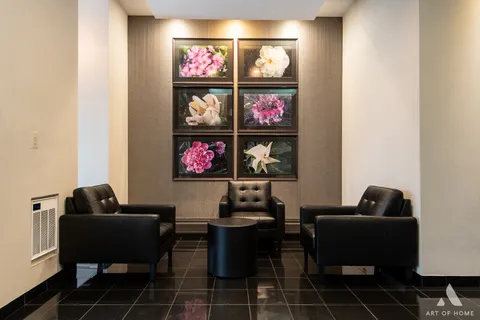 a living room with furniture a rug and a wall painting