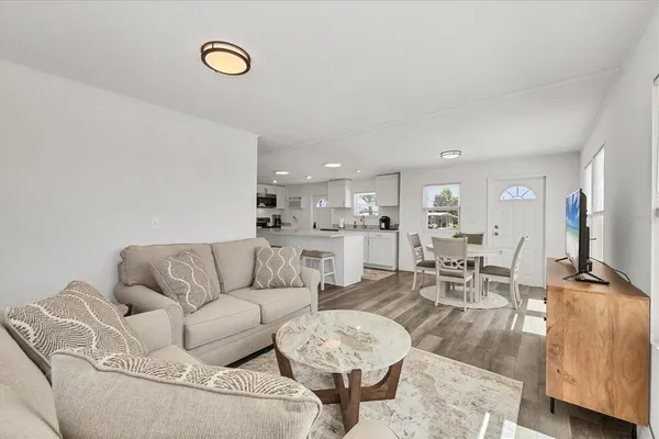a living room with furniture and wooden floor