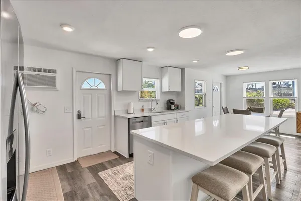 a large kitchen with a table and chairs in it
