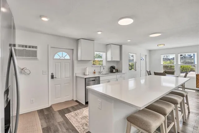 a large kitchen with a table and chairs in it