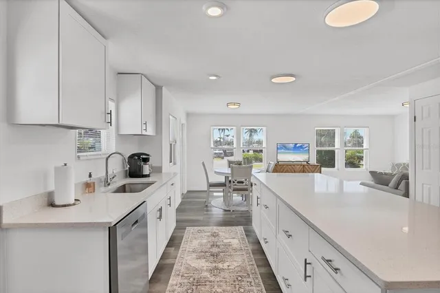 a large kitchen with a large counter top appliances and cabinets