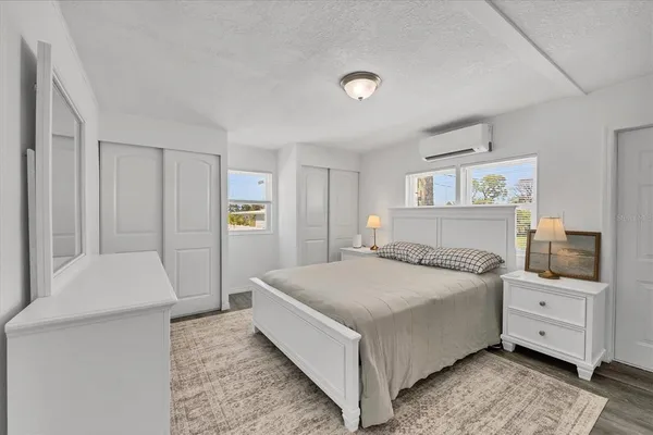 a bedroom with a bed and cabinets