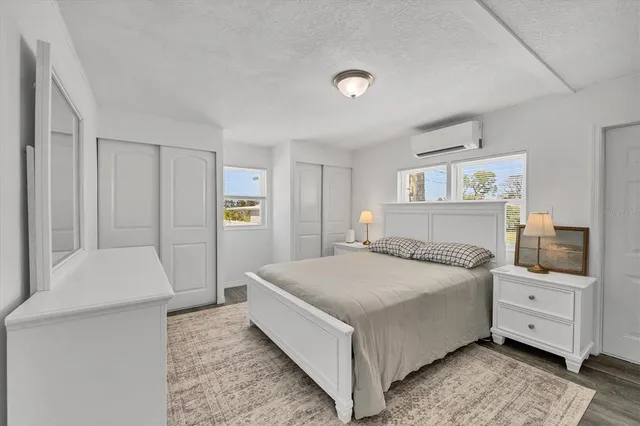 a bedroom with a bed and cabinets