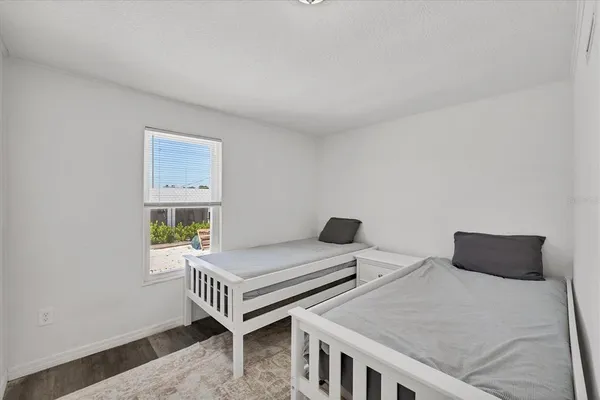 a bedroom with two beds and a window