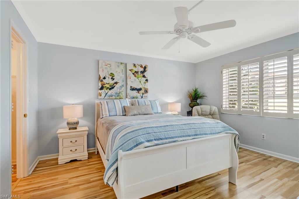 49 High Point Circle South, Unit 104 Naples, FL 34103 - Photo 15 of 30 a bedroom with a bed and a window