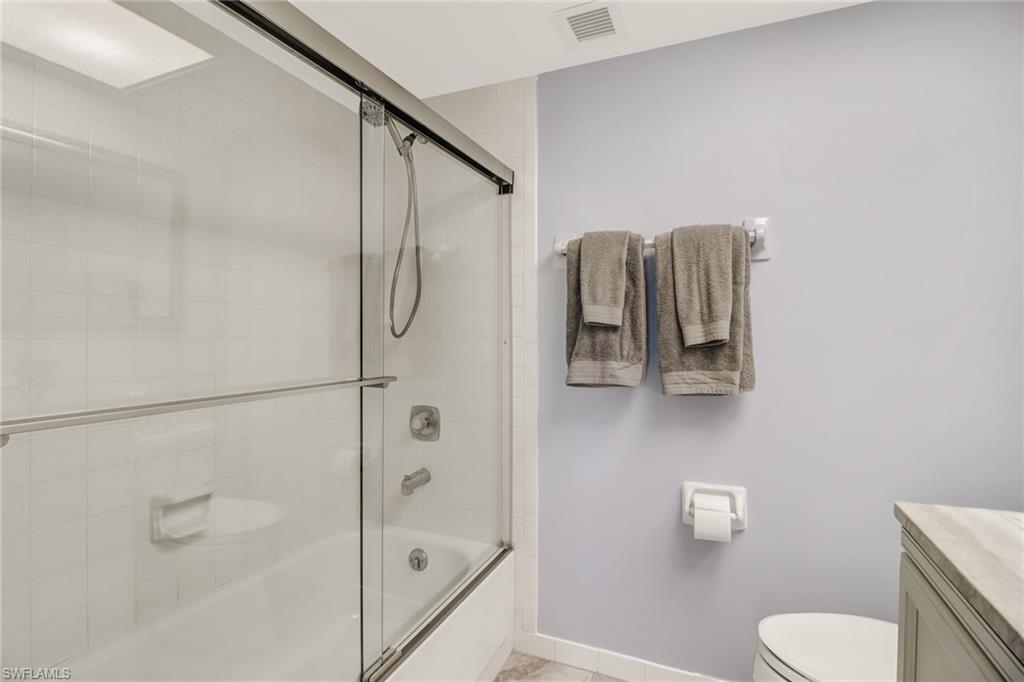 49 High Point Circle South, Unit 104 Naples, FL 34103 - Photo 19 of 30 a bathroom with a shower a toilet and a shower