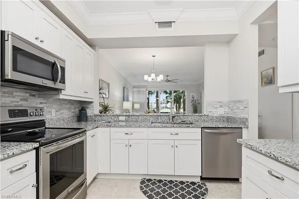 a kitchen with a sink stove and microwave