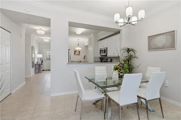 a view of a dining room with furniture and chandelier