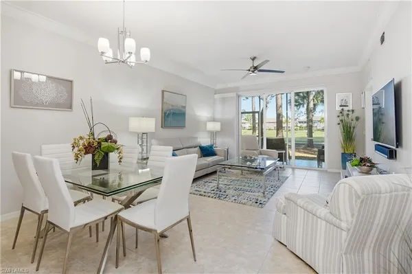 a living room with furniture chandelier and a flat screen tv