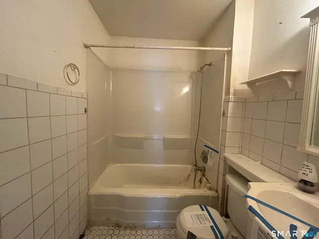 an empty room with closet and a bathroom