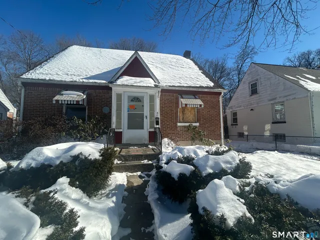 a view of a house with a yard and patio