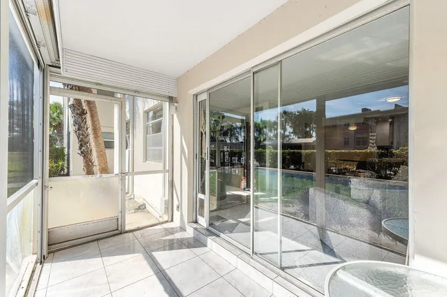 a bathroom with a glass door shower and a sink