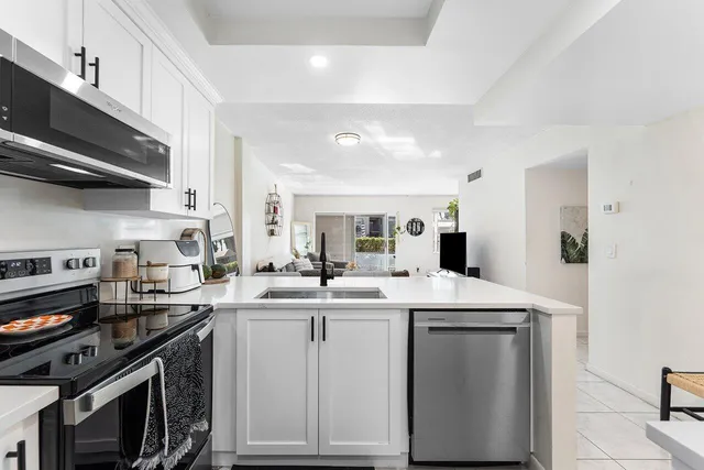 a kitchen with a sink stove and cabinets