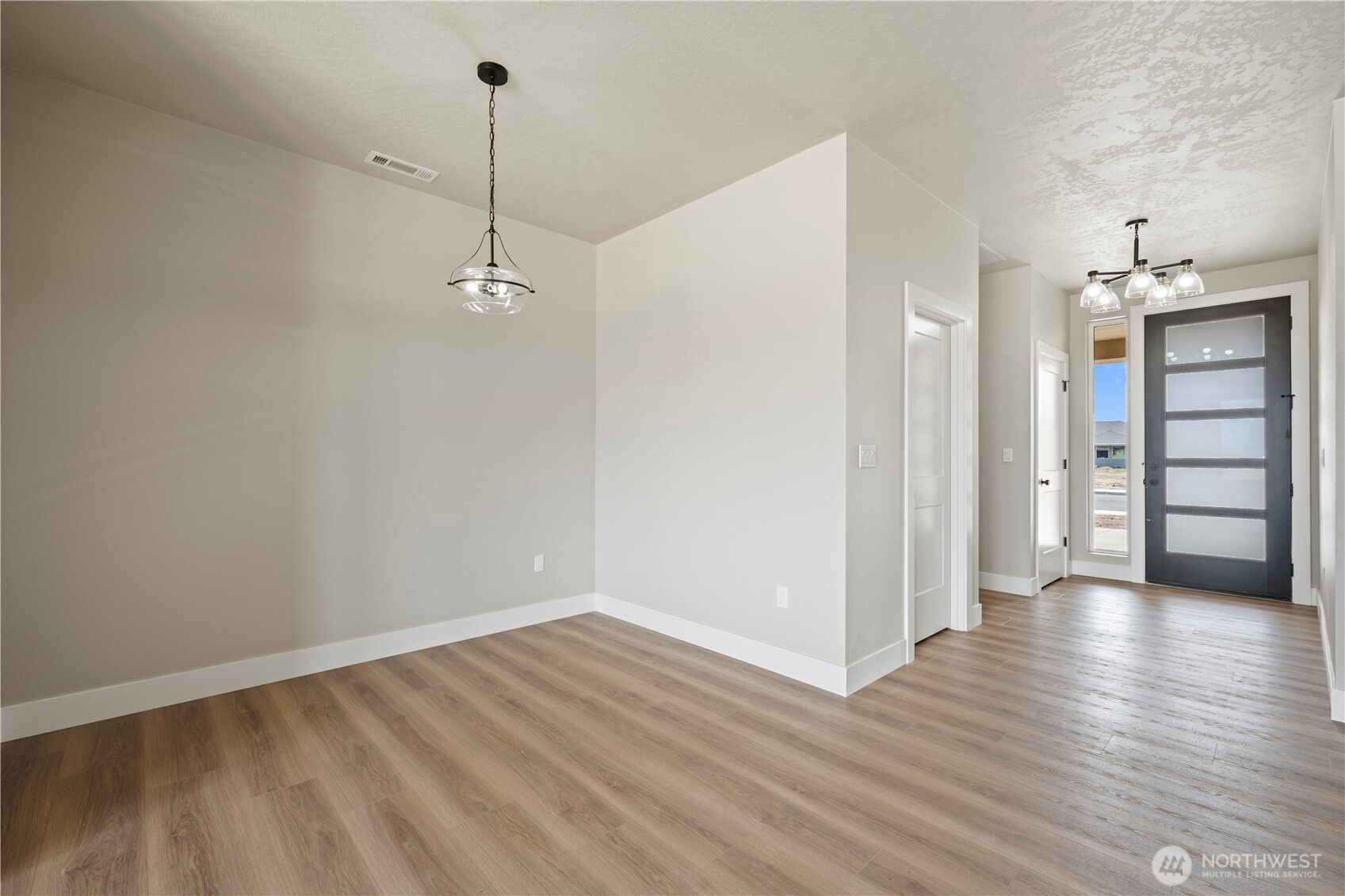 1229 E Mount Othello, WA 99344 - Photo 15 of 31 a view of a room with wooden floor and a ceiling fan
