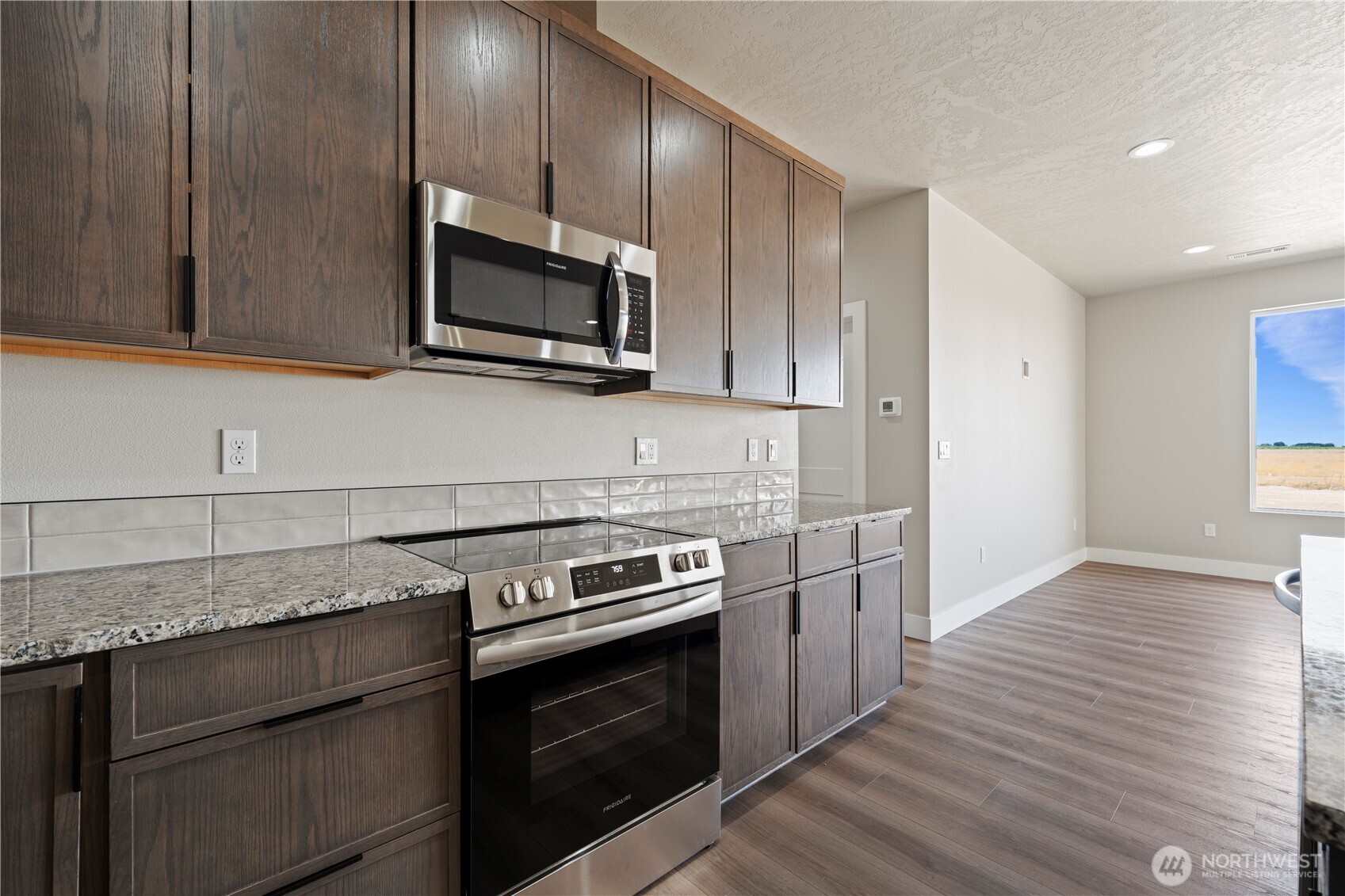 1229 E Mount Othello, WA 99344 - Photo 17 of 31 a kitchen with a stove and a microwave