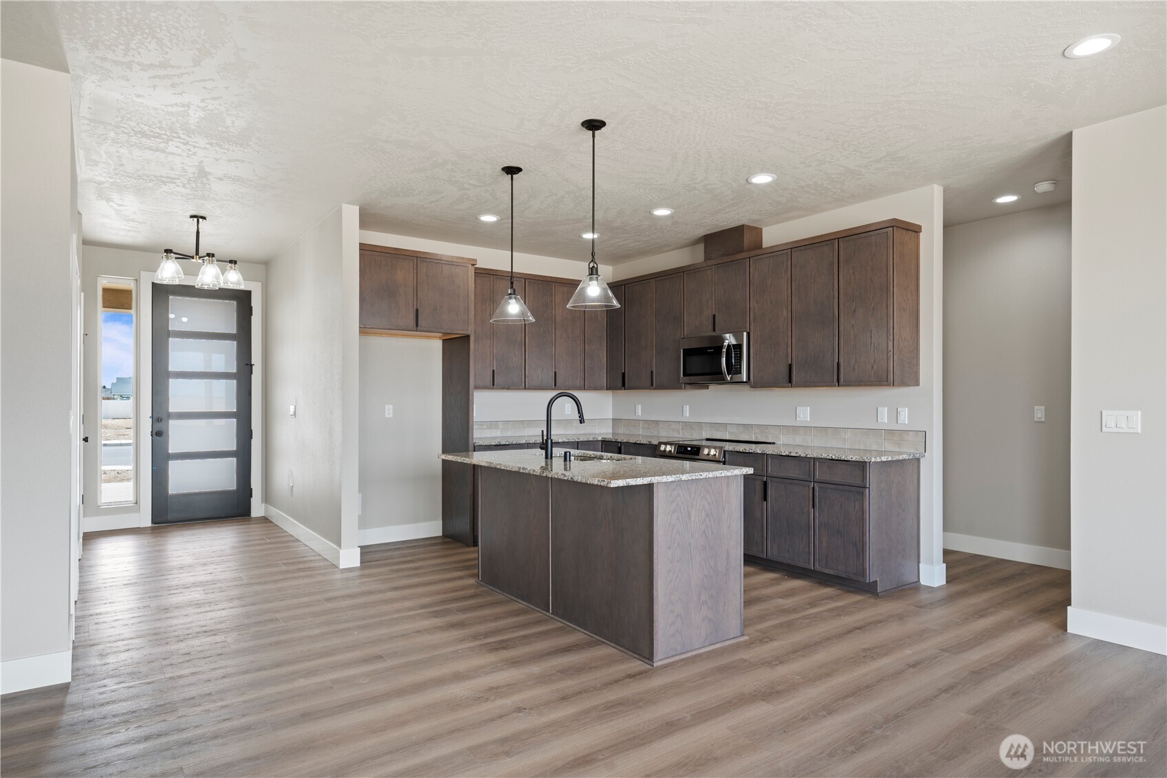 1229 E Mount Othello, WA 99344 - Photo 21 of 31 a kitchen with stainless steel appliances granite countertop a sink a stove and a refrigerator