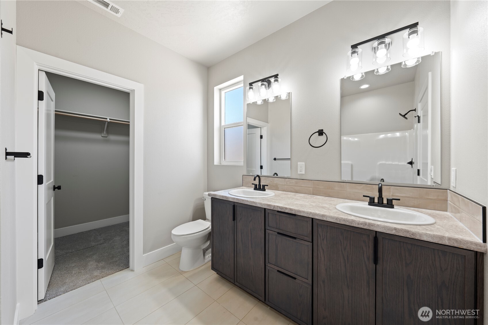 1229 E Mount Othello, WA 99344 - Photo 24 of 31 a bathroom with a double vanity sink mirror and toilet