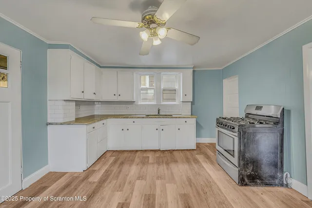 a kitchen with a stove a sink and a refrigerator