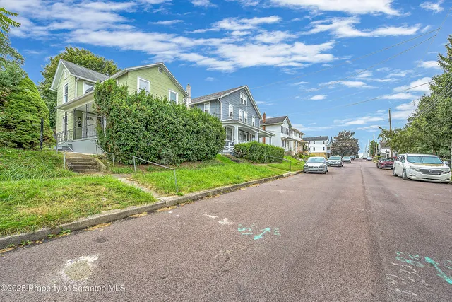 a couple of cars parked in front of a house
