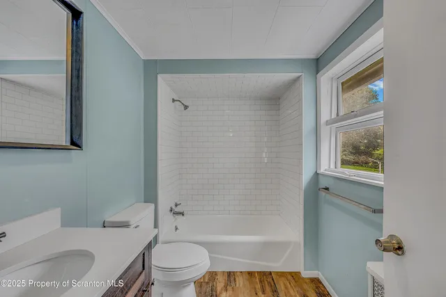a bathroom with a toilet a sink and bathtub