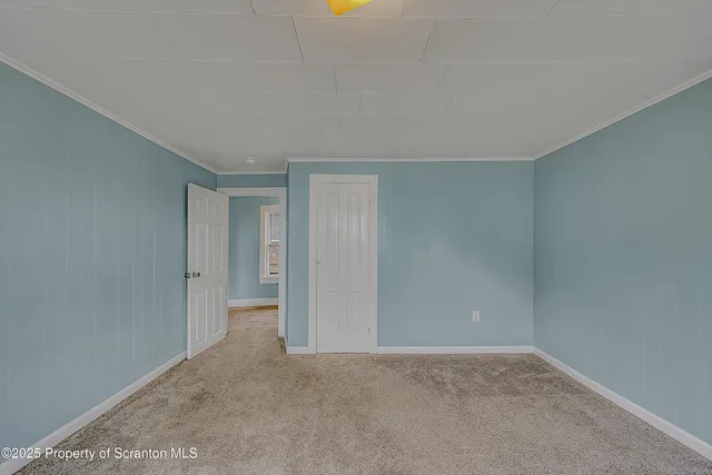 a view of an empty room and closet area