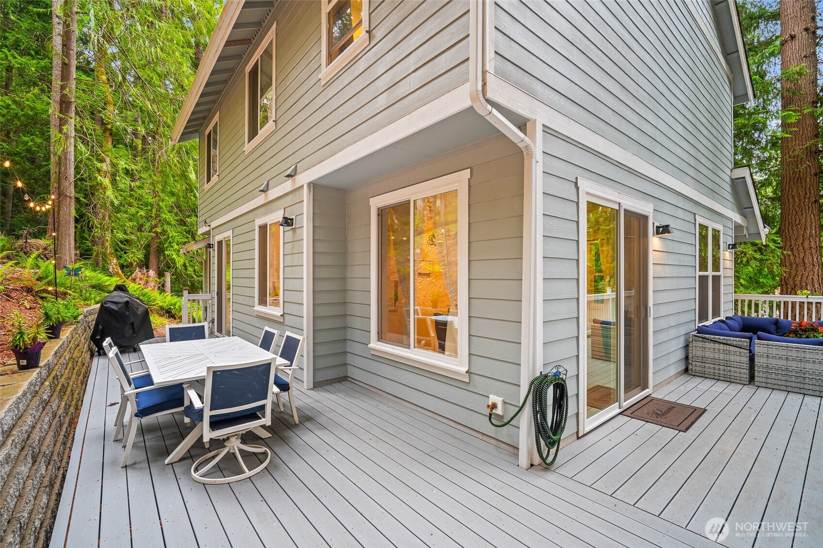 23 Spring Court Bellingham, WA 98229 - Photo 30 of 38 a view of a patio with table and chairs and wooden floor