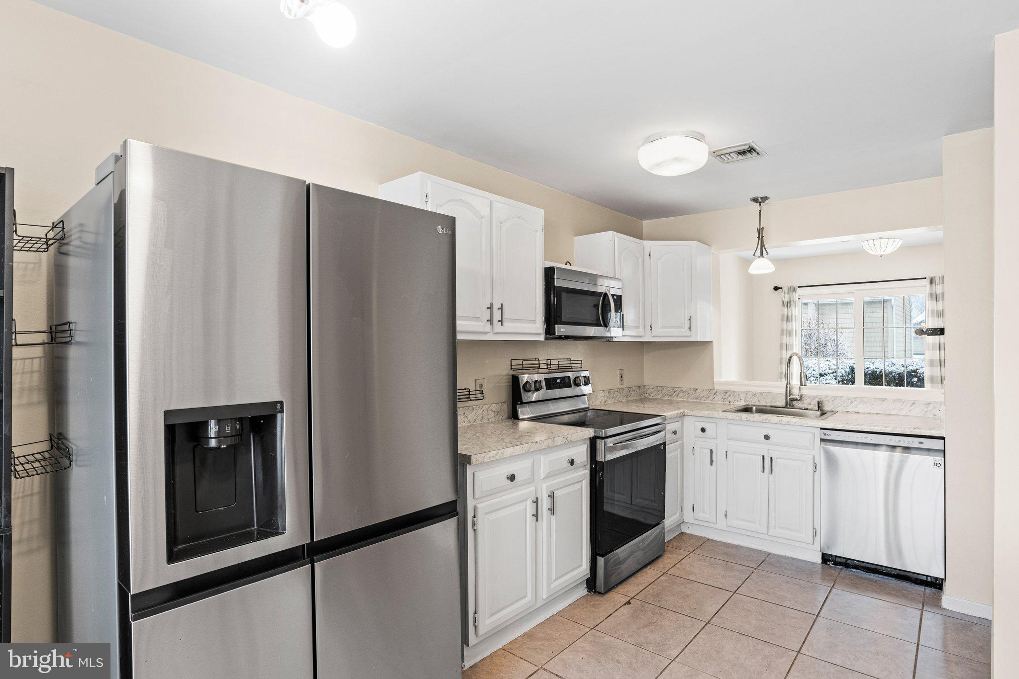 207 Crescent Drive Hershey, PA 17033 - Photo 12 of 42 a kitchen with cabinets stainless steel appliances and a counter space