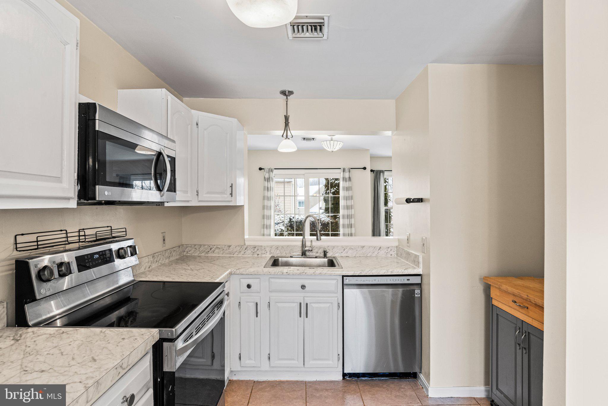 207 Crescent Drive Hershey, PA 17033 - Photo 13 of 42 a kitchen with kitchen island granite countertop a sink and steel appliances
