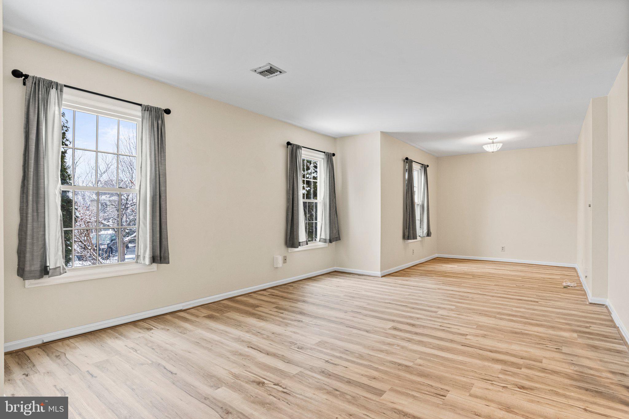 207 Crescent Drive Hershey, PA 17033 - Photo 6 of 42 a view of an empty room with window and wooden floor
