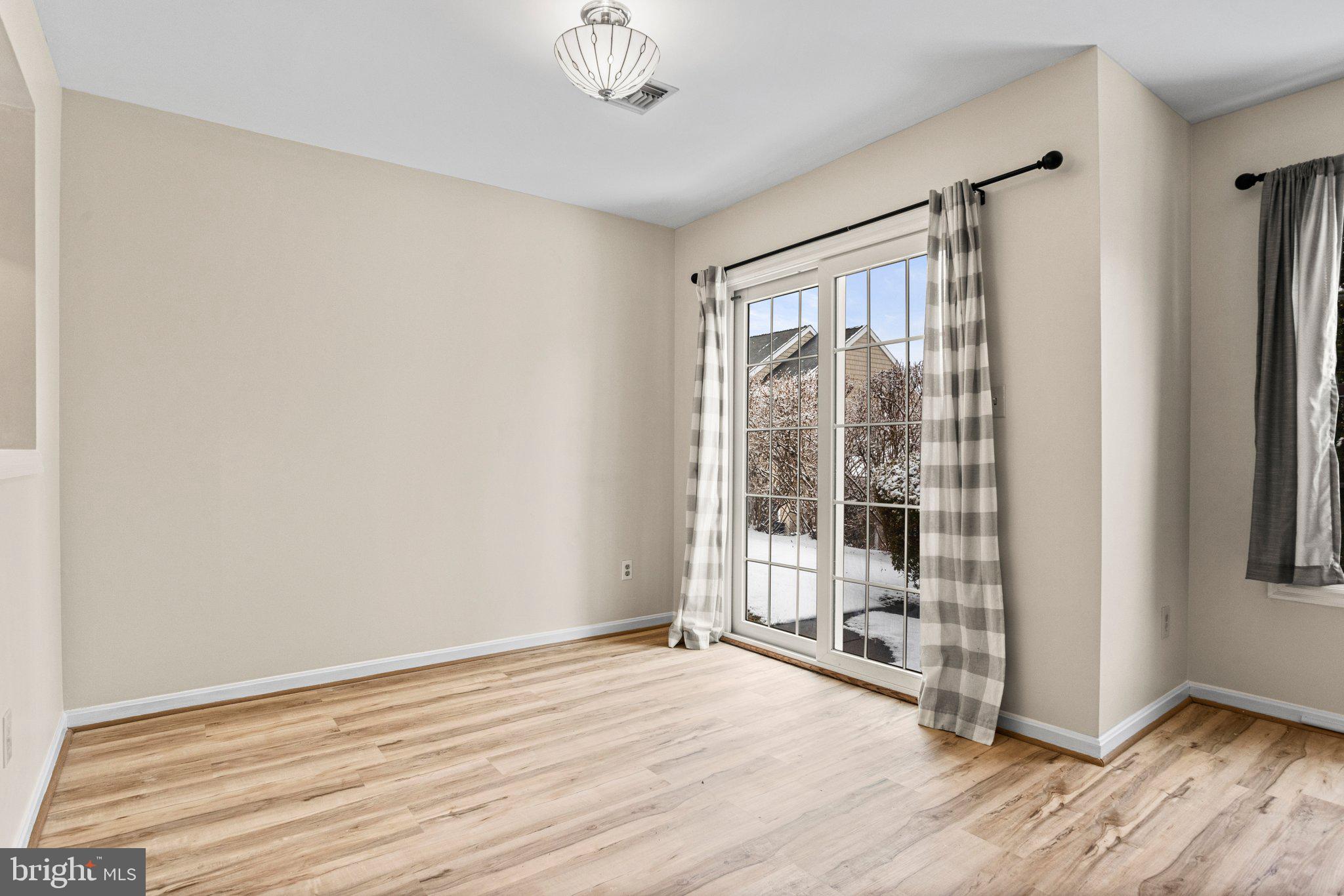 207 Crescent Drive Hershey, PA 17033 - Photo 8 of 42 an empty room with wooden floor and windows