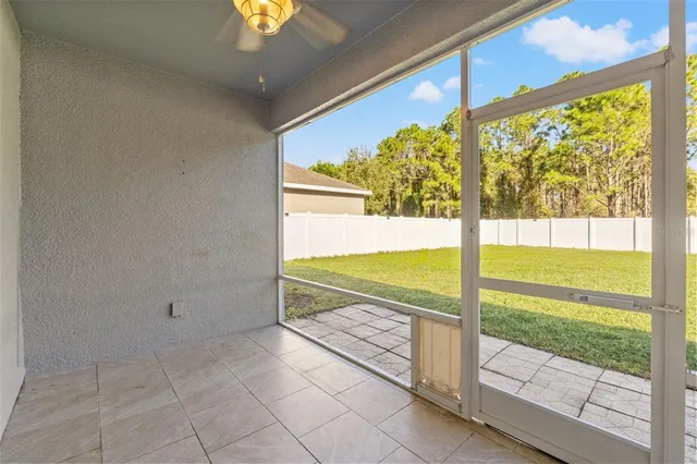 a view of an empty room with a floor to ceiling window and an outdoor view