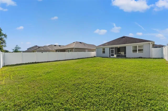 a view of a house with a yard and sitting area
