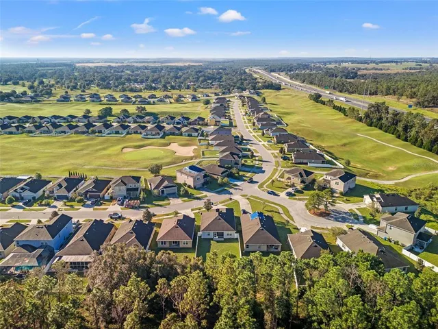 an aerial view of residential building with outdoor space lake and houses with outdoor space