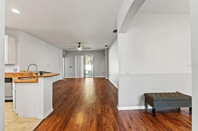 a view of a kitchen with a sink and wooden floor