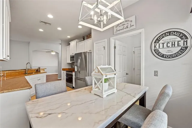 a dining room with furniture and a large window