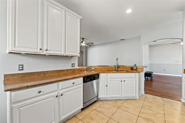 a kitchen with granite countertop a sink and cabinets