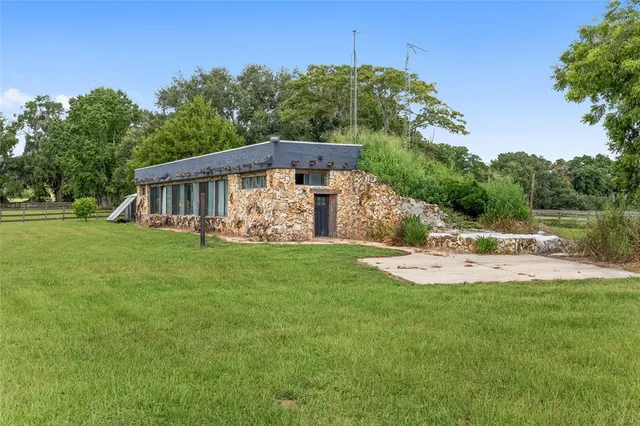 a view of a green field with wooden fence