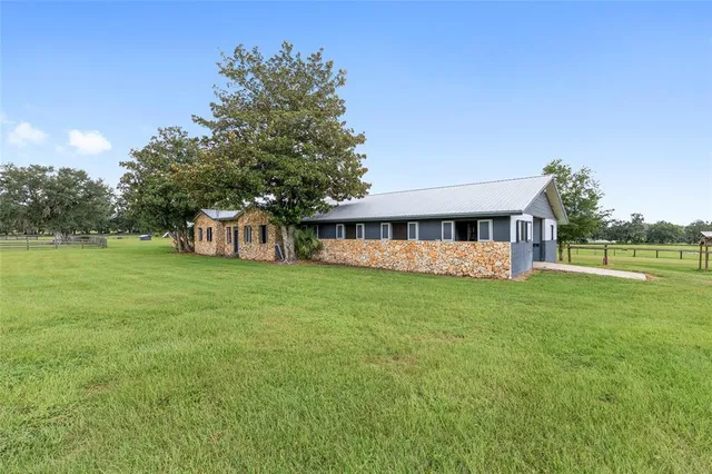 a view of a green field with wooden fence