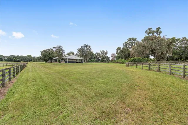a backyard of a house with lots of green space and trees all around