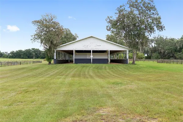 a big yard with lots of green space and trees