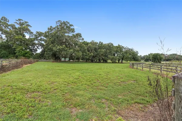 an aerial view of a houses with a yard