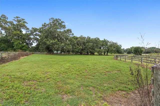an aerial view of a houses with a yard