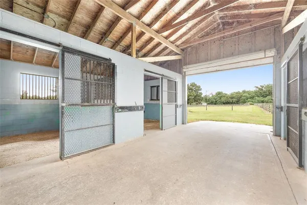 a view of a green field with wooden fence