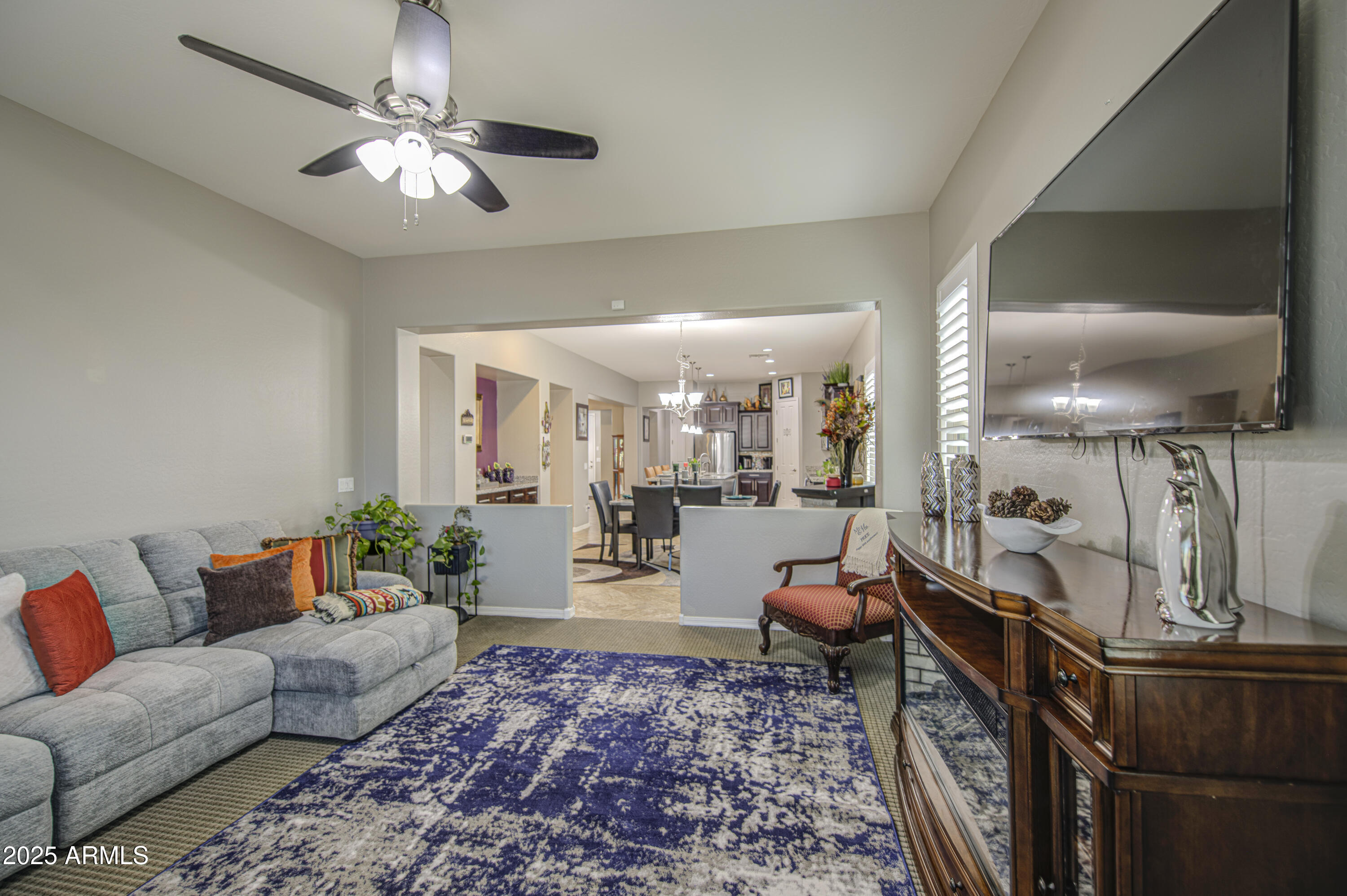 14304 West Coronado Road Goodyear, AZ 85395 - Photo 17 of 66 a living room with furniture and a chandelier