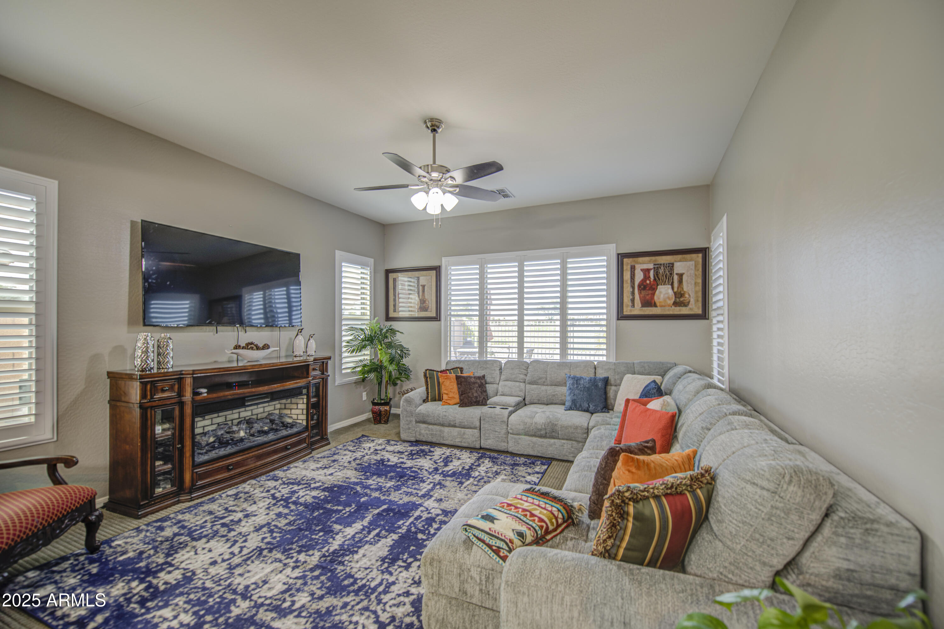 14304 West Coronado Road Goodyear, AZ 85395 - Photo 22 of 66 a living room with furniture and a flat screen tv